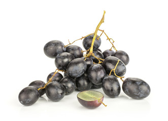 Black grape cluster (autumn royal variety) with one sliced half isolated on white background.