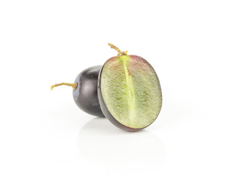 Black grape (autumn royal variety) one berry and section half isolated on white background.