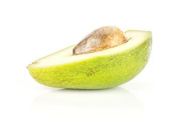One green smooth avocado half with a brown seed isolated on white background bacon variety.