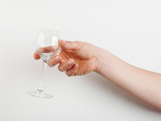 empty glass of wine in hand on a white background