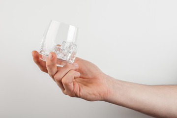 empty glass of wine in hand on a white background