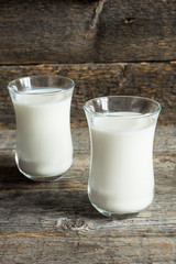 Fresh healthy milk in glass cups on wooden rustic background