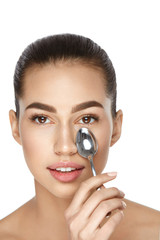 Beauty. Woman With Cold Spoon Near Eye