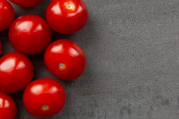 Cherry tomatoes on grey textured background