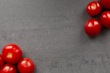 Cherry tomatoes on grey textured background