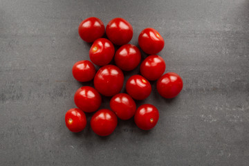 Cherry tomatoes on grey textured background