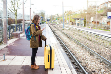 girl tourist  waits for the train