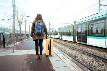 girl tourist  waits for the train