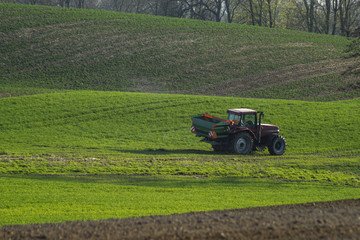 tractor with seeder sowing grain in spring