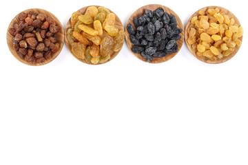 Collection of raisins in wooden bowl isolated on a white background with copy space for your text. Top view. Flat lay