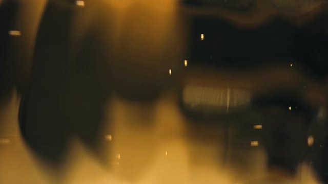 Yellow and orange bubbles floating in an abstract warm liquid. Dark background with soft focus