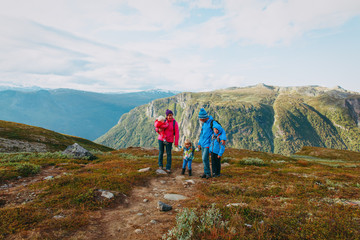 happy family with kids hiking in mountains
