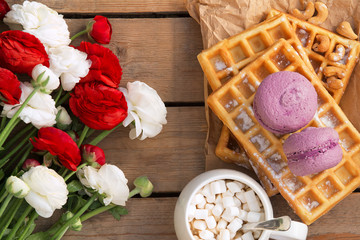 Ranunculus flower, Belgian waffles, macaroons and coffee - perfect breakfast 