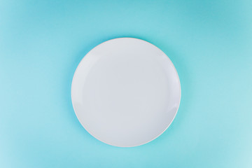 A white plate on the blue background.