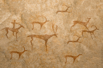 An ancient image of animals on a cave wall painted by an ancient man. history, archeology,...