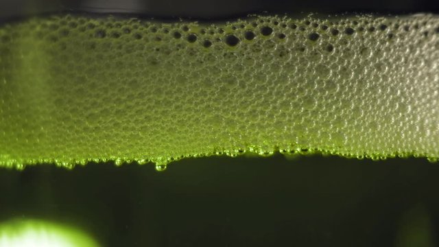 Green bubbles floating on a liquid radioactive poison. 
