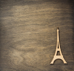 eiffel tower toy at plywood background surface