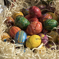 Colorful Easter wooden eggs in wooden chips shop for sale
