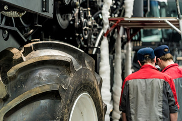 Industrial worker assembles agricultural equipment
