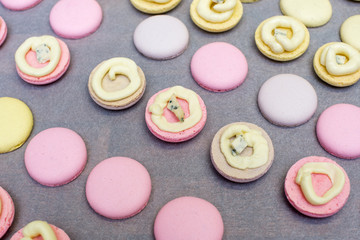cooking, confectionery and baking concept - macarons on table