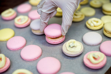 cooking, confectionery and baking concept - macarons on table