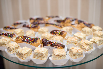 a lot of pastry custard Napoleon on a round glass plate.