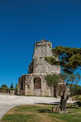 Fototapeta na wymiar View of the Tour Magne (Magna tower) with blue sky, in the high part of the Gardens of the Fountain, in the city center of Nimes. Located in the Gard department, Occitanie region in southern France