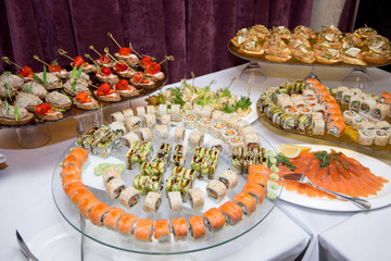 Japanese Cuisine -Buffet catering style Sushi Set in restaurant - salmon Maki Sushi and Nigiri Sushi. selective focus