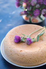 Sponge cake and bouquet of clover
