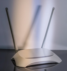 wifi router stands on a mirror surface on a white background