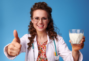 paediatrist doctor showing thumbs up and giving a glass of milk