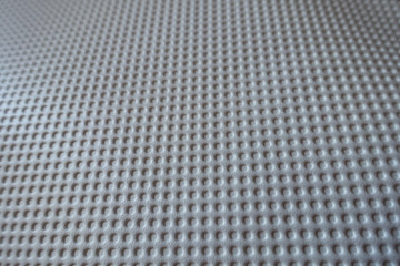 Closeup of white material with embossed polka dots