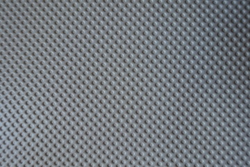 Texture of white material with embossed polka dots