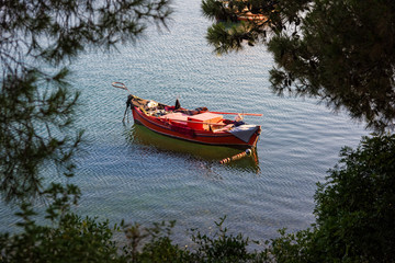 Traditional wooden fishing boat at a sea shore near Mt Pelion in Thessaly, Greece