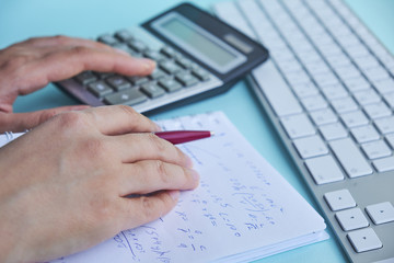 woman working with calculator, business document and laptop computer notebook