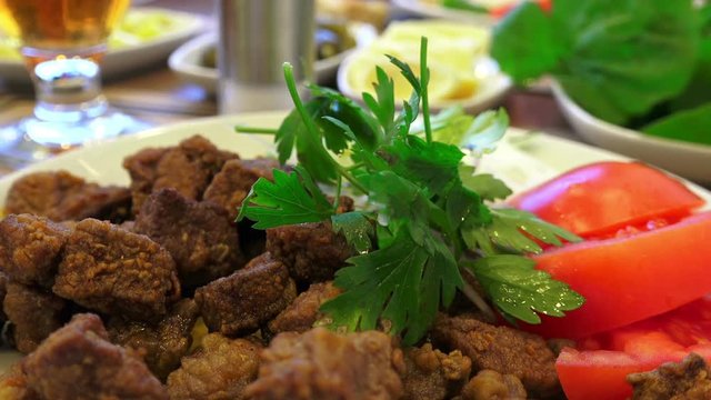 Fried liver with tomatoes and parsley, close up, HD video, 1080p