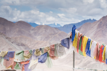 Tibetan prayer flags with mantra on mountain Himalaya view background.