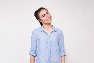Obraz premium Portrait of a happy beautiful young brunette girl on a white background.