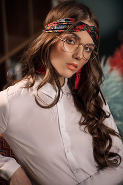 Retro female model posing in eyeglasses.