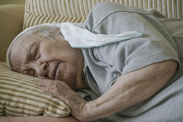 Senior woman sleeping on sofa