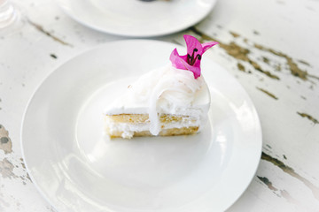 Homemade coconut cake garnish with pink flower