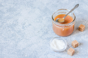 Homemade salted caramel sauce. Selective focus, space for text.