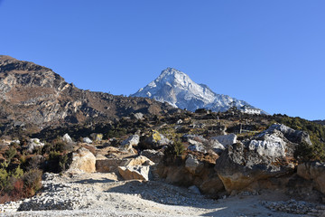 Prayer stones above Namche Bazaar and snowcapped Mount Khumbila in the background