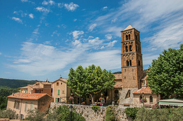 Fototapeta na wymiar Panoramic view of houses, church and belfry in the charming village of Moustiers-Sainte-Marie. In the Alpes-de-Haute-Provence department, Provence region, southeastern France