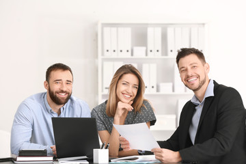 Businessman consulting young couple in office
