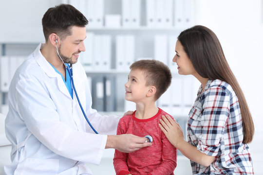 Children's doctor examining little boy in hospital