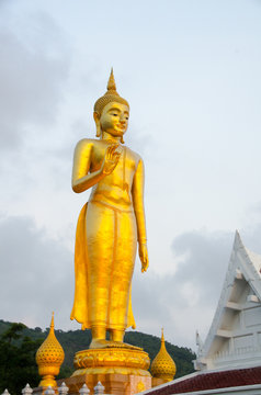 Standing Buddha image.The attitude of persuading the relatives not to quarrel symbol of Golden Buddha statue  at Kho Hong Hill, Hatyai, songkhla, Thailand