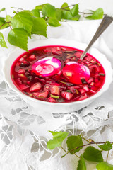 Traditional cold soup with okroshka of beetroot, cucumber and spring onion spring vegetarian dish super food on light background with copy space in rustic style