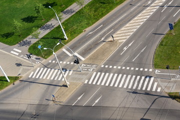 Crosswalk and bike crossing line on empty crossroad, driverless technology
