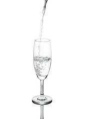 pure water pouring flowing in to wine glass isolated on white background with clipping path.